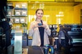 Smiling Coffee shop owner standing behind counter with cup of coffee